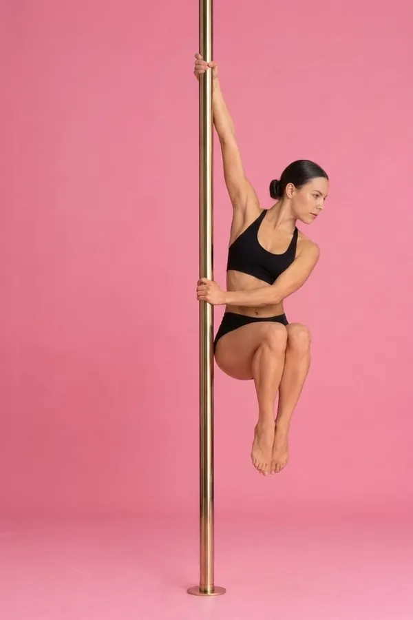 Dancer holding a Chair Spin on a chrome pole, from the Coquet combo library